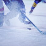 ice hockey player in action kicking with stick