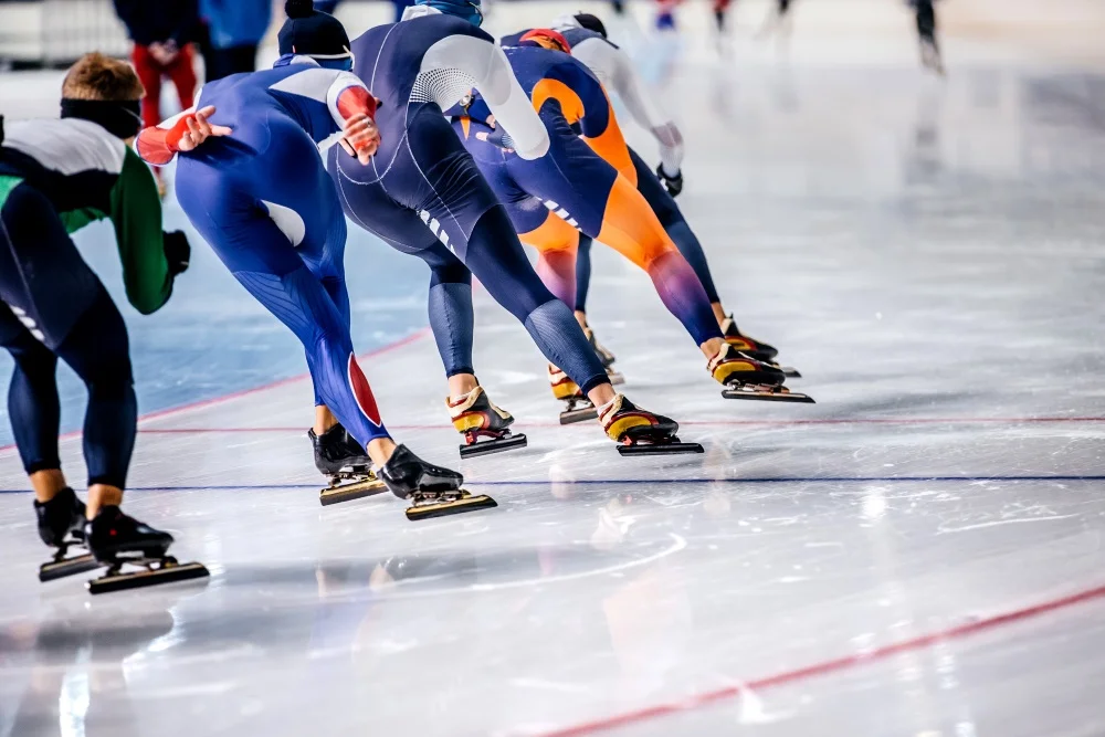Symbolfotogroup of men skating on ice sports arena. warm-up before competitions in speed skating