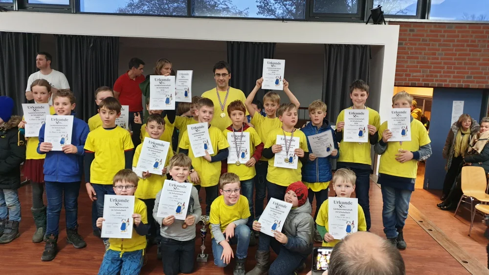 Das Gros der Schachkinder der Grundschule Lichtenhagen nach der Siegerehrung, da ist sogar der Siegerpokal etwas in den Hintergrund gerückt. Foto: Kirsten Klingner-Grundmann Die Grundschuleaus der Mühlengemeinde (Rostock Lichtenhagen) ist Landesmeister