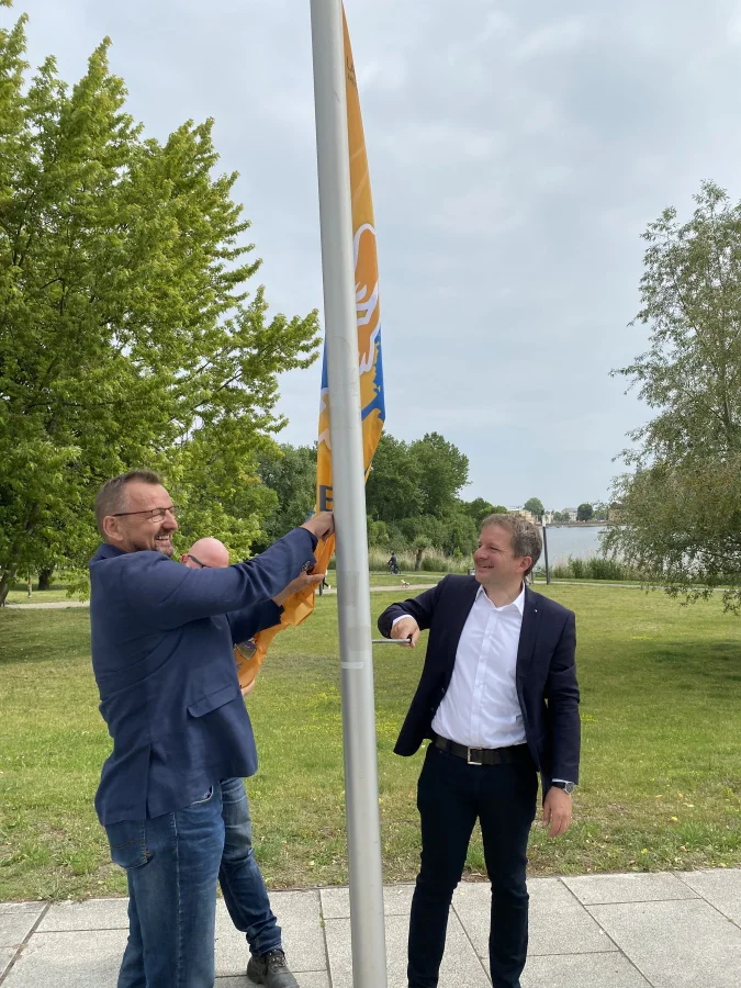 Schwerins Oberbürgermeister Rico Badenschier (r) und LSB-Geschäftsführer Torsten Haverland (l) hissen am Bertha-Klingberg-Platz die Flagge der Jugendsportspiele. Foto: LSB MV