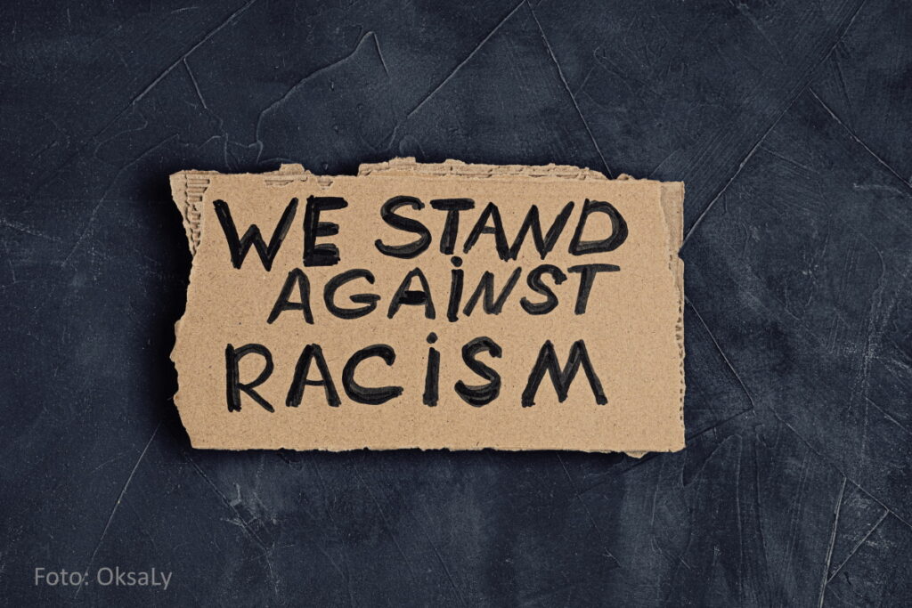Pappschild: We stand against racism