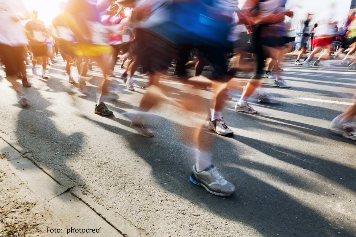große Gruppe von Marathonläufer:innen auf dem Asphalt